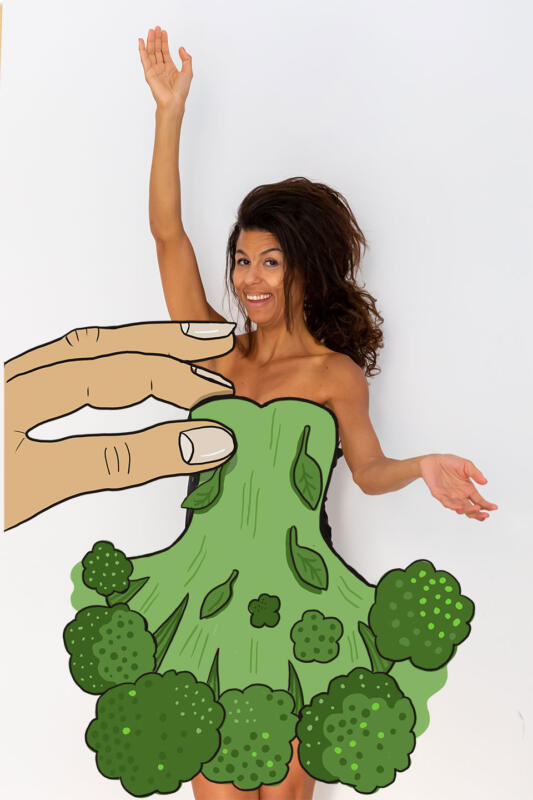 Illustration av kvinna med grön klänning gjord av broccoli