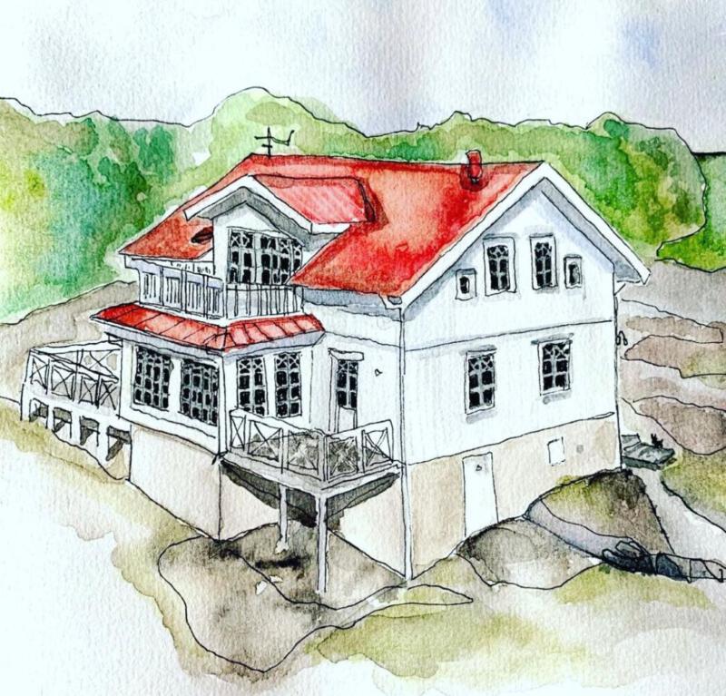 Vitt hus med rött tak på klippor