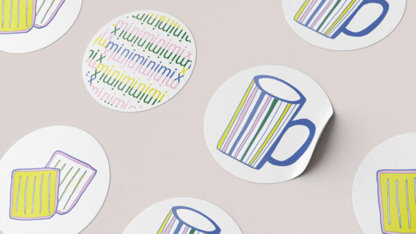 round stickers with the logotype, a hot chocolate cup and sandwiches made form kids drawings