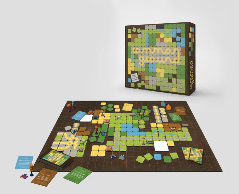 Overview of the board game Common Ground, showing the tiles, game pieces, cards and box.