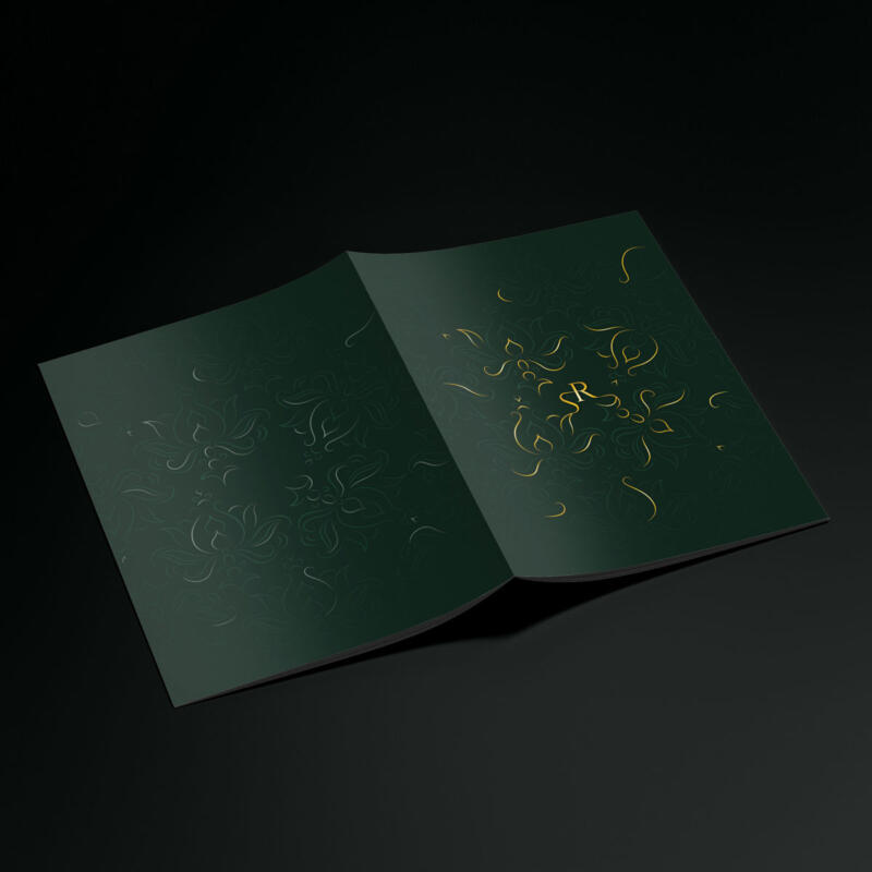 Restaurant menu front and back covers showing a flower pattern and monogram