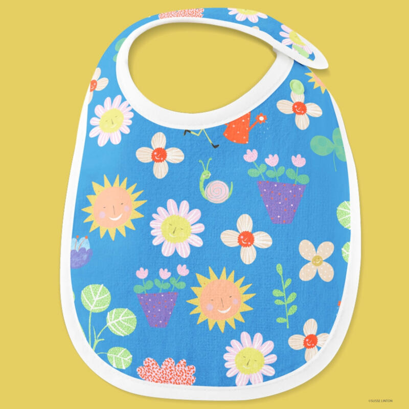 A photograph of Happy-Play-Fun-Garden pattern on babies bib  by illustrator Susse Linton