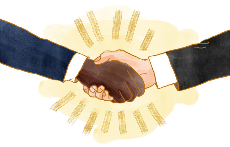 Två händer möts i ett handslag, bildsätter temat diplomati.
