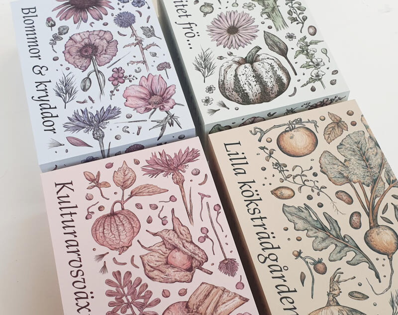 Fyra presentaskar för fröer med illustrerade blommor, kryddor och grönsaker på.