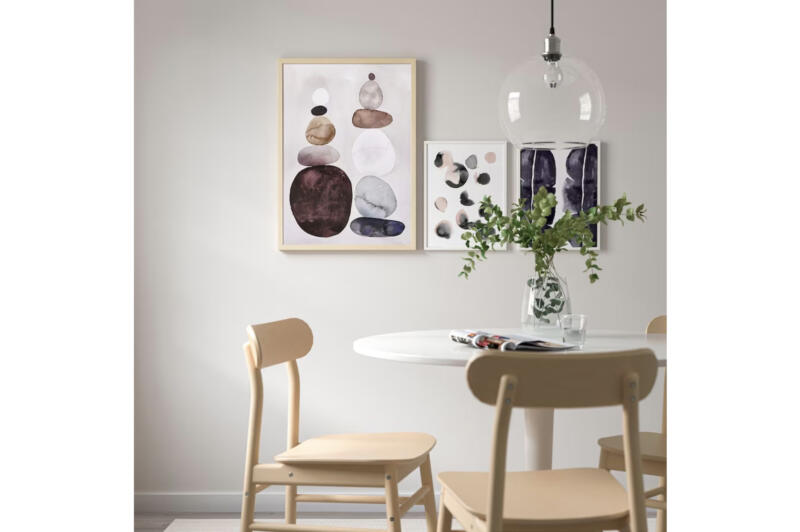 A watercolour motif framed picture in a light dining room area.