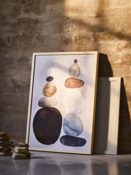 A watercolour motif framed picture leaning against a rendered wall.