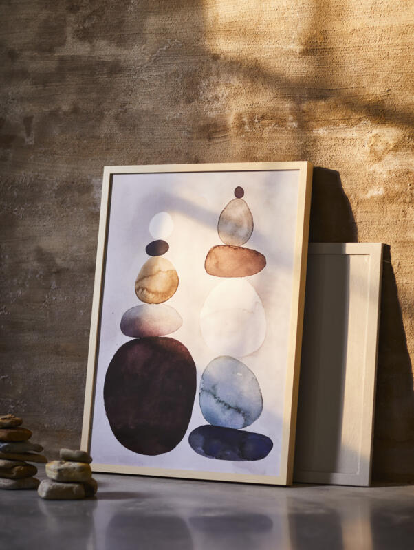 A watercolour motif framed picture leaning against a rendered wall.