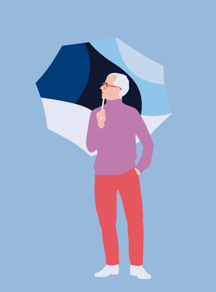A senior man standing with an umbrella 