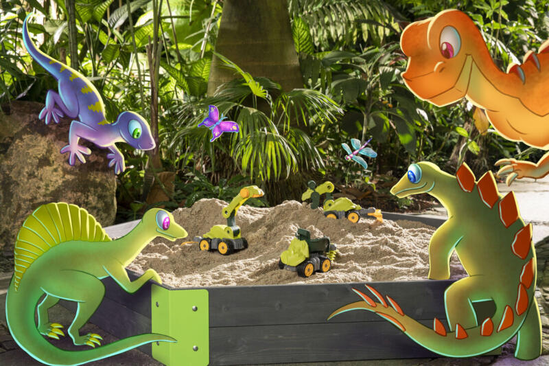 Tecknade dinosaurier samlas kring fotograferade leksaker i en sandlåda.