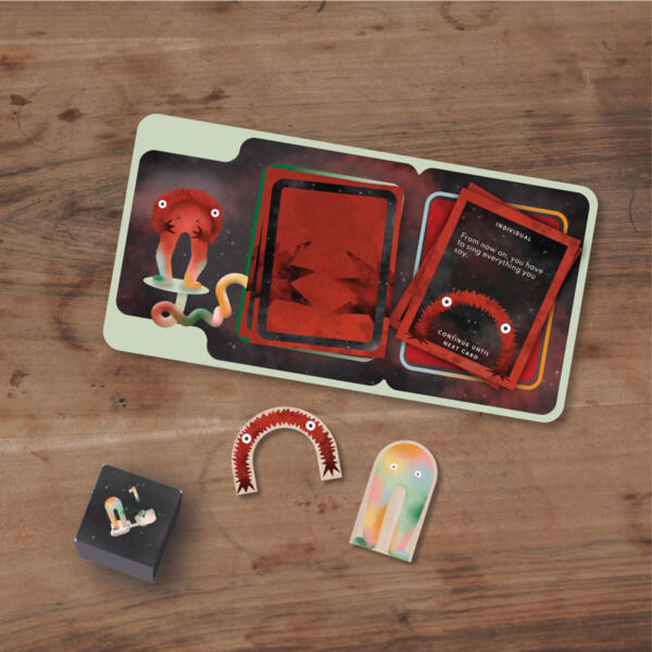 Boardgame pieces showing cards, a board, dice and the two characters of the game