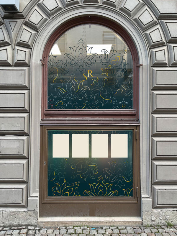 Window display for an elegant Indian restaurant showing their logo and a flower pattern