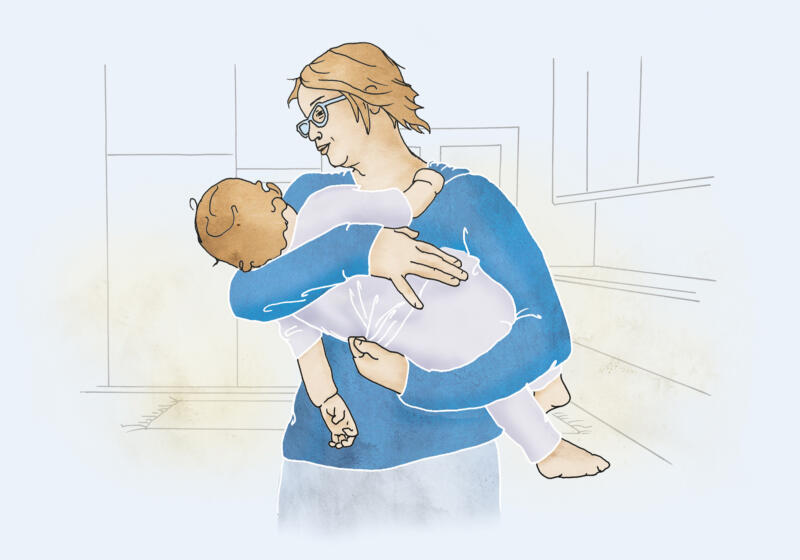 Illustration av mamma med bebis i famnen stående i ett kök