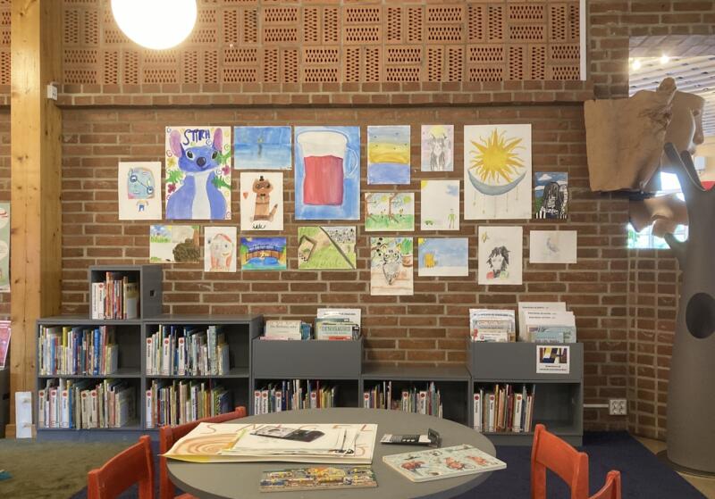 Exhibition of children’s artwork on a library wall